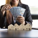 Who Pays Realtor Fees In Massachusetts? Guide For Buyers And Sellers Real estate agent counts her real estate commission after helping a buyer sell a home