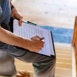 Home inspector filling out a paper inspection report