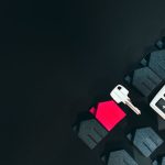 How Soon Can You Sell A House After Buying It? Miniature home, house key, and calculator with a black background.