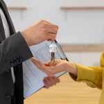 Is Selling Your Home In A High Market A Smart Move? Real estate agent handing house keys to new owner