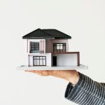 When Selling A House Do You Have To Take The Highest Offer? hand presenting model when selling a house