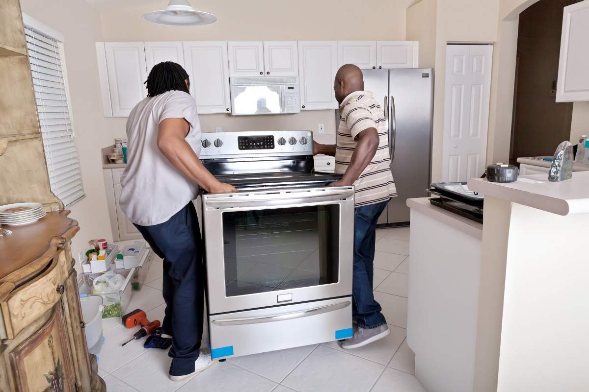Men installing new appliances before selling house