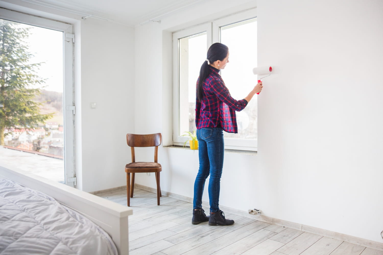A woman conducting home improvements and repairs before selling a home