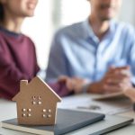 How You Can Sell Your Home And Still Live There After The Sale Couple discussing home sale with agent