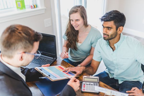 A real estate agent selling a house to customers