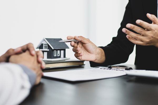 Man discussing sale-leaseback with realtor.
