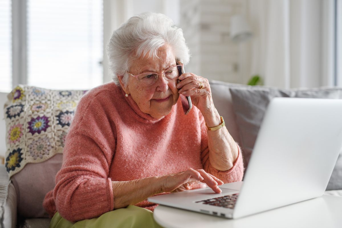 Elderly woman speaking on the phone about selling her home.