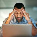 How To Manage The Stress Of Selling A House Overwhelmed seller struggling with the challenges of selling a house.