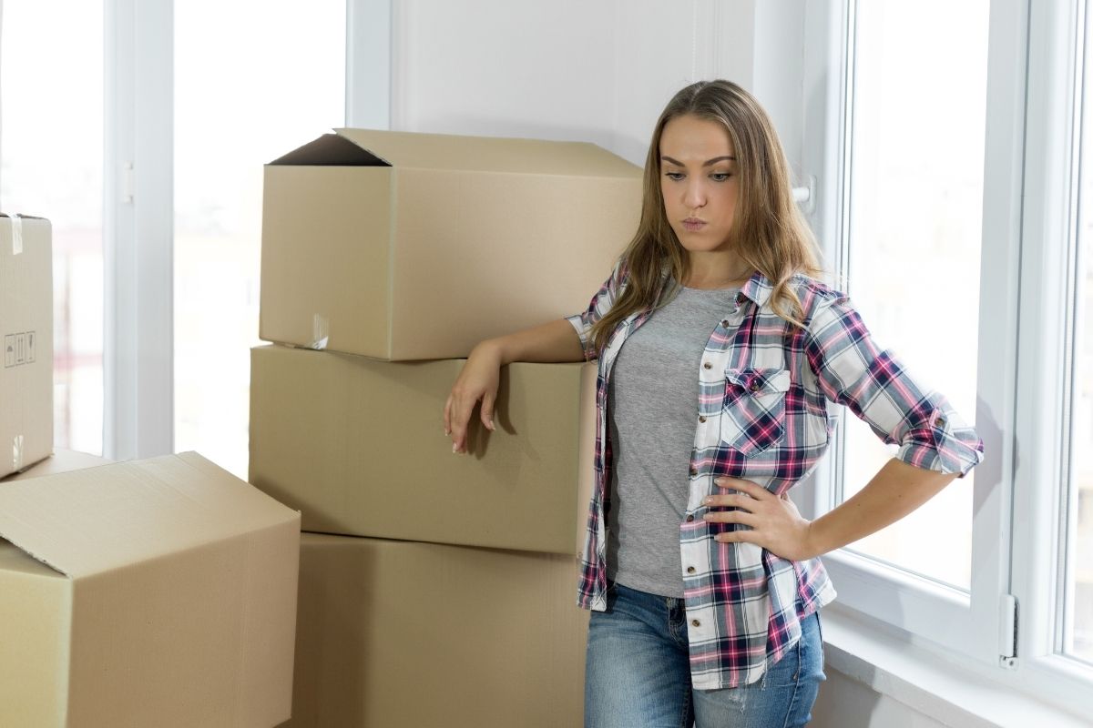 Woman considering belongings before leaving home