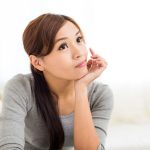 What To Fix Before Selling A House Woman planning repairs before selling a house