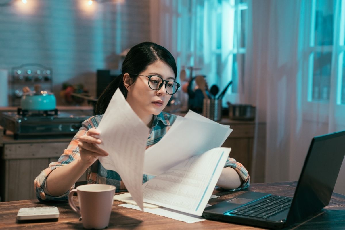 Woman preparing documents to sell a house