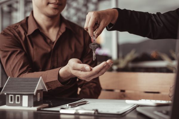 Agent handing out keys of the house to the new owner.