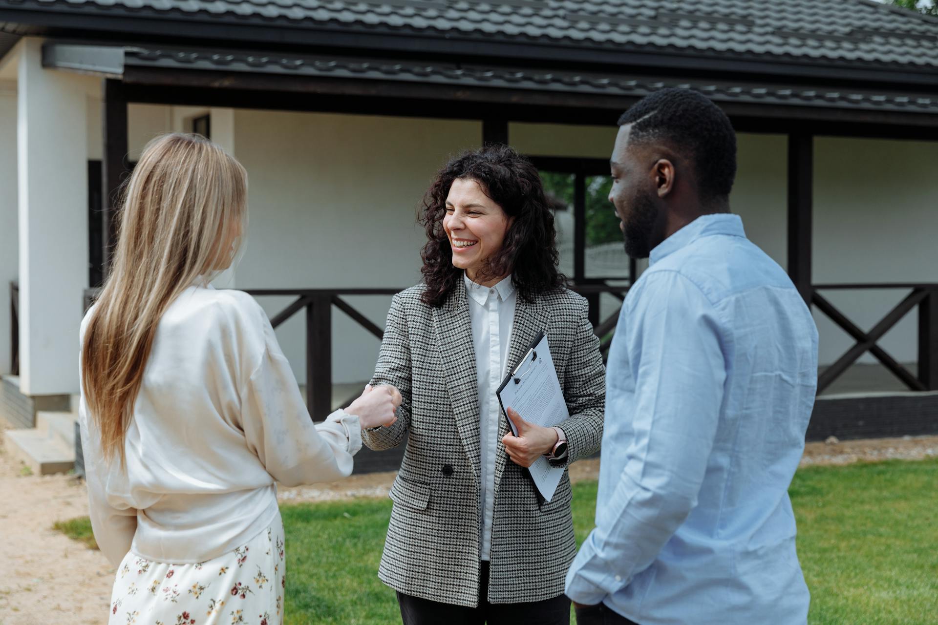 A woman shaking hands with a real estate agent