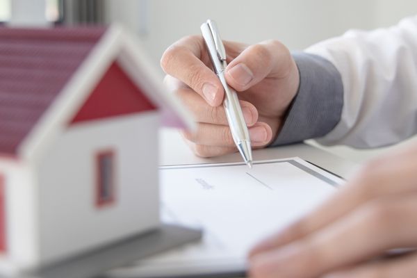 Man preparing paperwork before selling a home