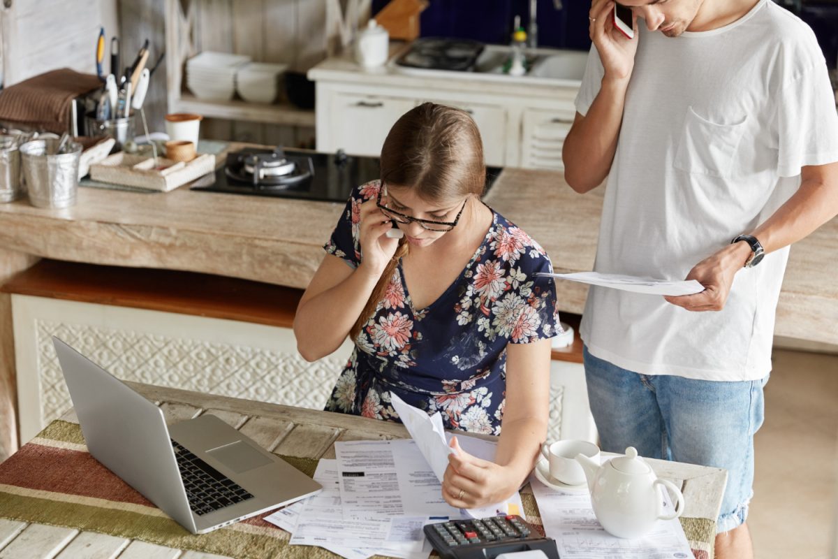 Couple reviewing paperwork for cash home sale