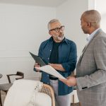 What Happens If You Sell Your House Before 2 Years Man consulting with an expert before selling his house.