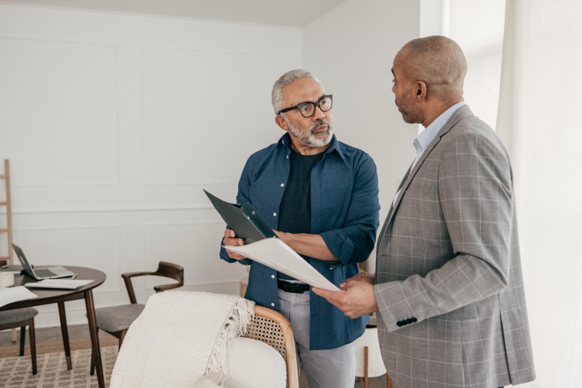Man consulting with an expert before selling his house.