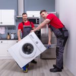 Men moving appliances in the house.