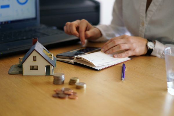 Person calculating money for all-cash house sale
