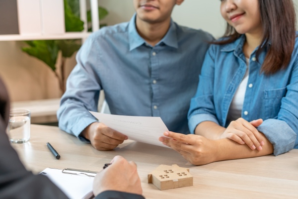 Couple reviewing the contract to sell a house.