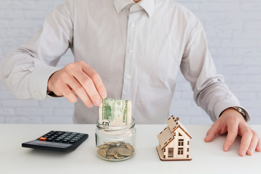 Budget planning with calculator and house showing moderate tips for increasing your home's value.