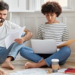 Can I Sell My House To Avoid Foreclosure? Busy couple reviewing documents about selling a house to avoid foreclosure