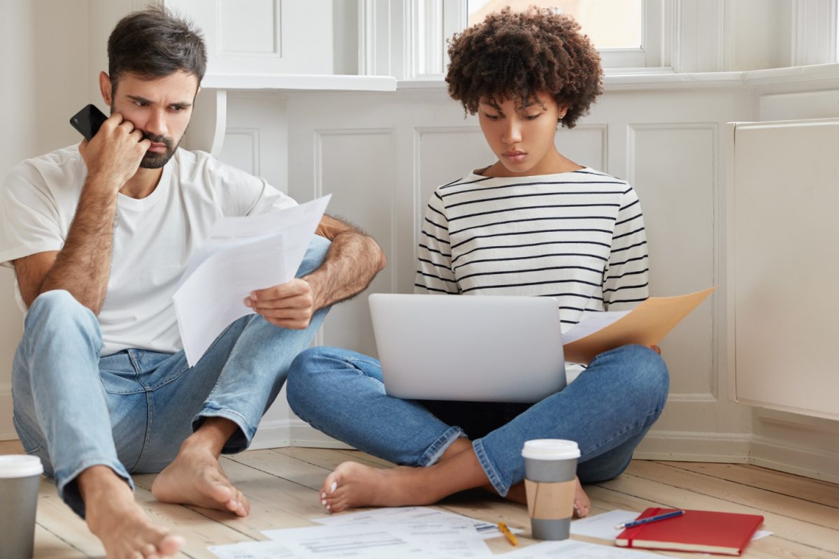 1. Busy couple reviewing documents about selling a house Busy couple reviewing documents about selling a house to avoid foreclosure