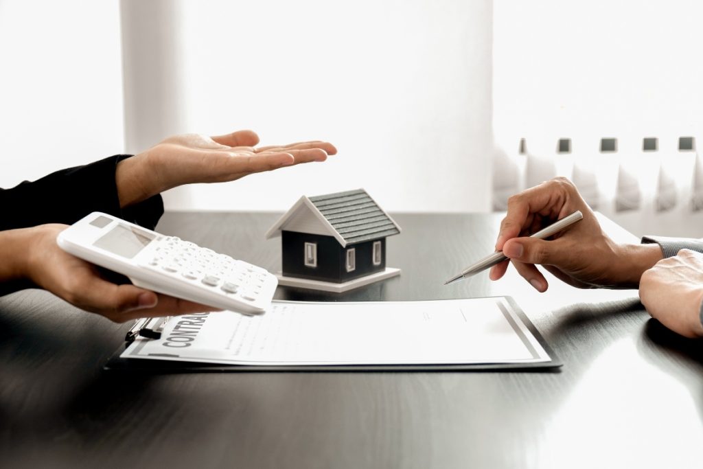 Seller reviewing closing cost details with buyer.