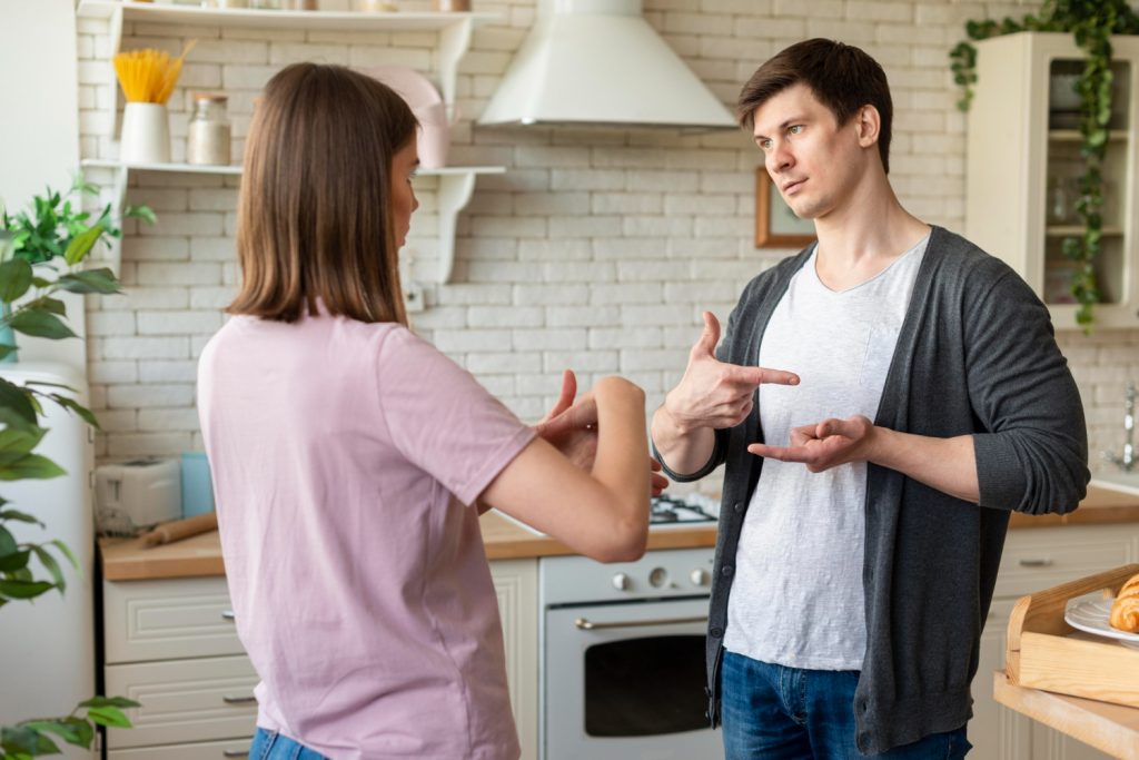 1.Couple discussing whether to sell their house as-is or make repairs