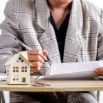 How to Find a Trusted We Buy Houses Company Woman reading real estate transfer tax basics