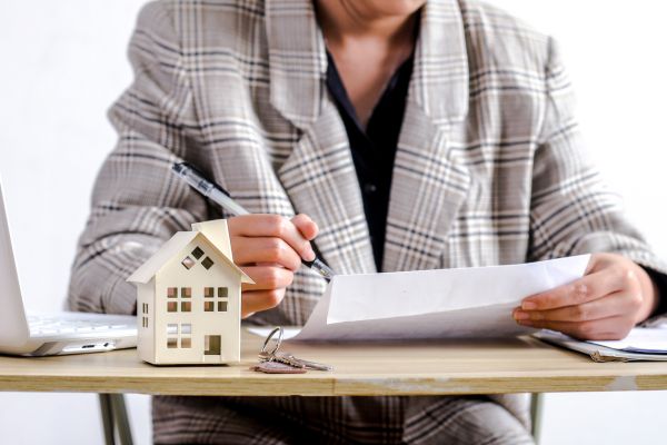 Woman reading real estate transfer tax basics