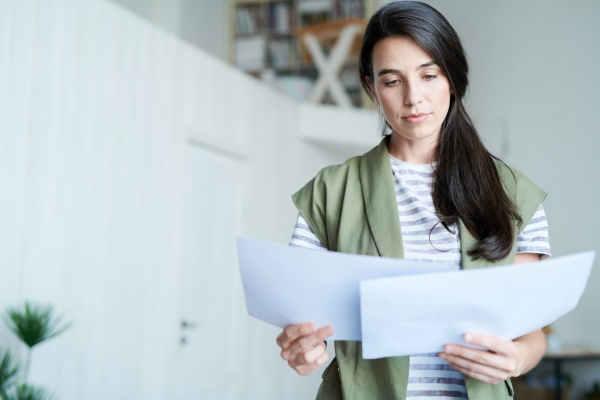 Woman reviewing offers while preparing to sell a house.