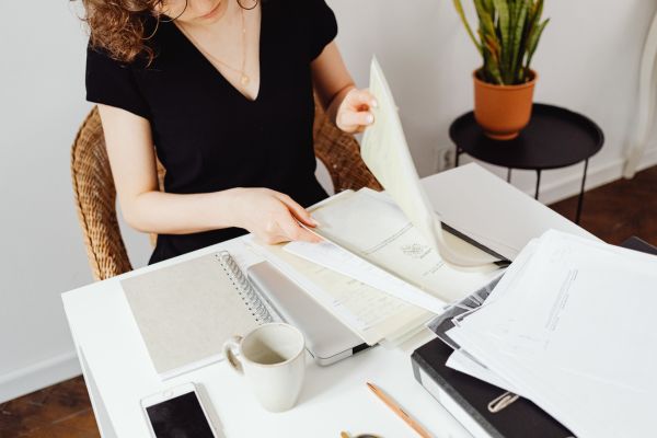Woman arranging paperwork for selling a New Hampshire home
