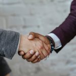 Types of Liens That Can Stop You From Selling Your House in Massachusetts hand shake after a house for sale negotiation