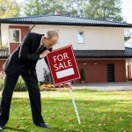 Best Time To Sell A House In Maine In 2026 Man putting house in maine for sale