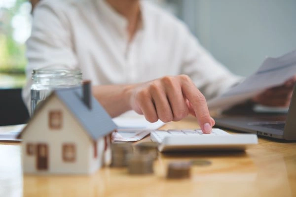 Woman calculating capital gain from home sale