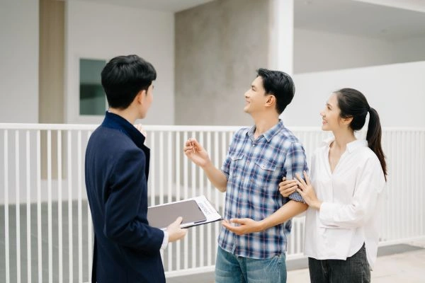 Couple discussing property with real estate agent