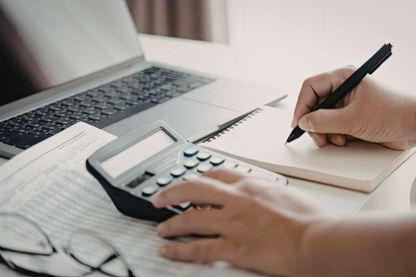 Woman calculating gains from house sale